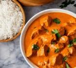 Butter chicken & basmati rice in bowls.